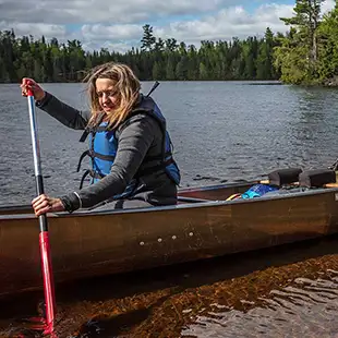 Woman paddling kevlar canoe lifejacket rockwood poplar bwca boundary waters