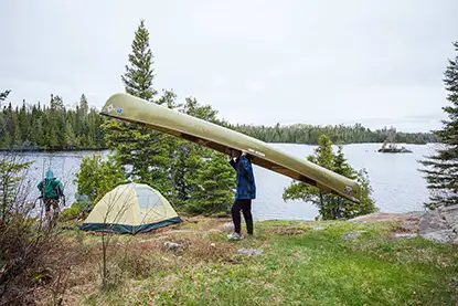 Trip Planning Portage canoe in camping area with tent